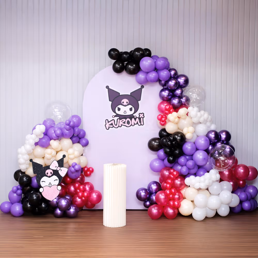 Balloon arch filled with bright purple, magenta, and black colors.