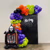 This Halloween decor with sequin, neon signage, and spooky balloons is perfect for any venue.