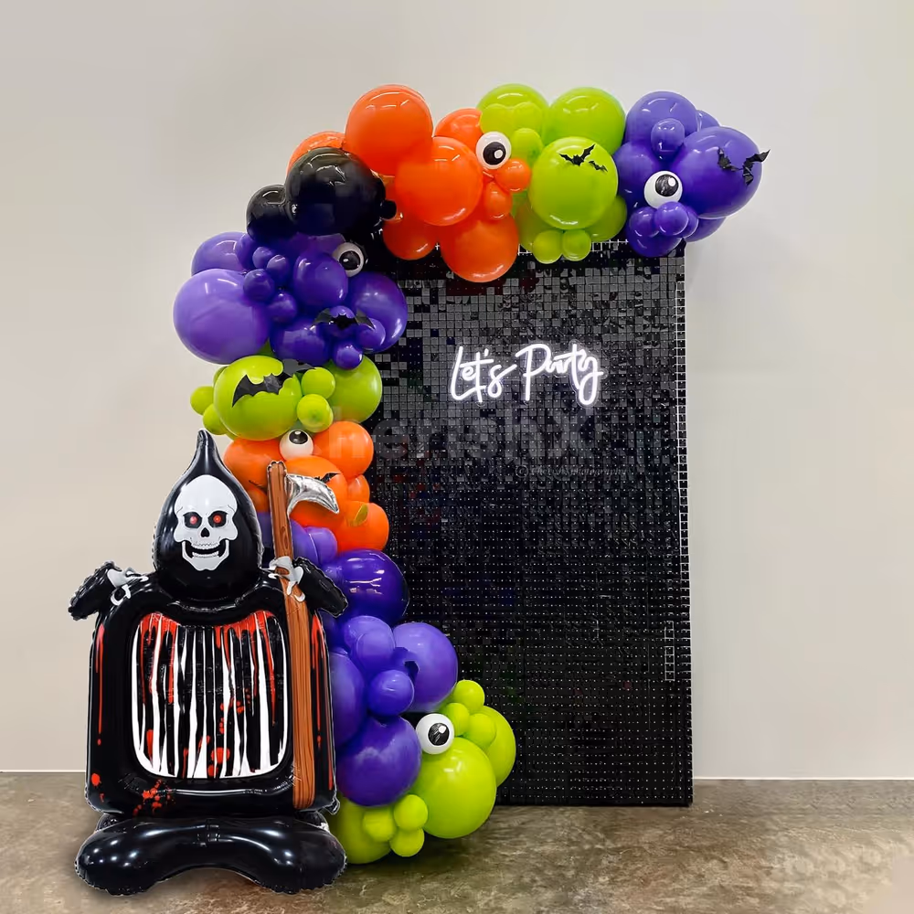 This Halloween decor with sequin, neon signage, and spooky balloons is perfect for any venue.