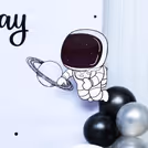 Dramatic balloon arch in striking metallics—blue, black, and silver.