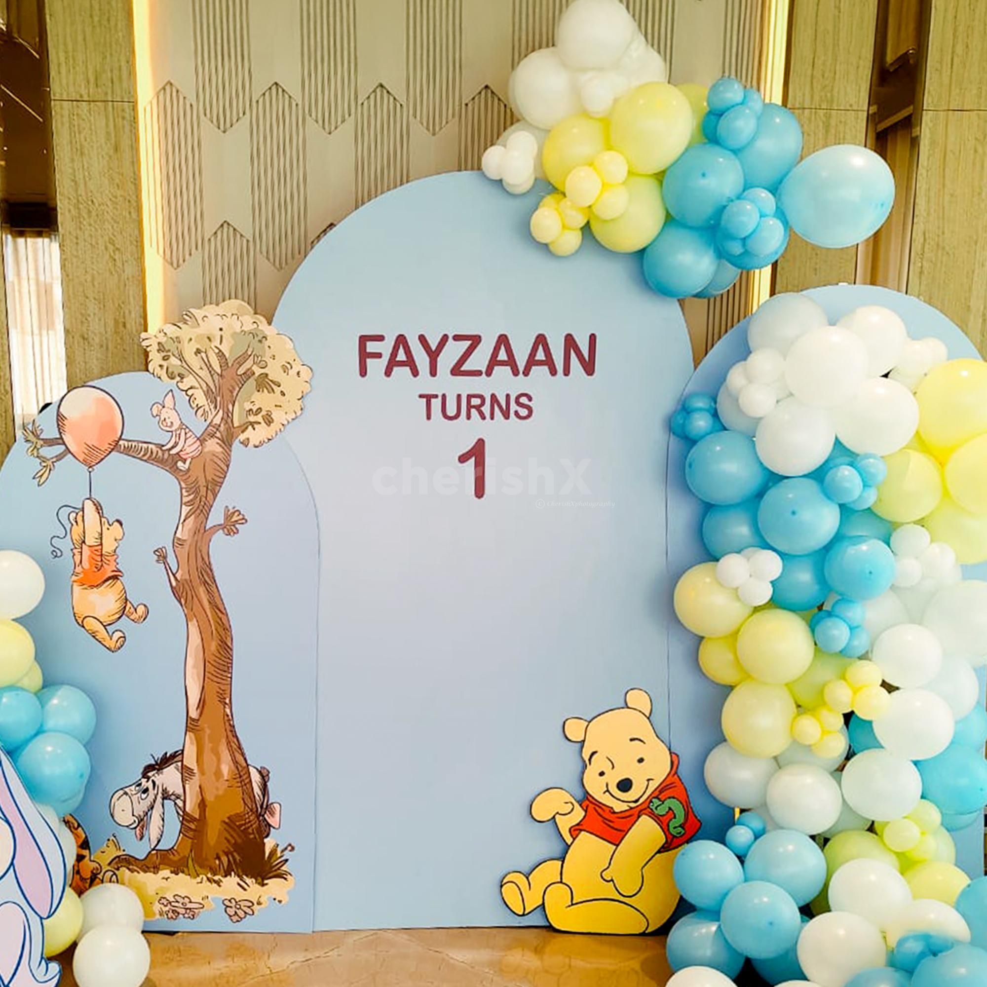 Soft macaron balloons finish the playful setup.