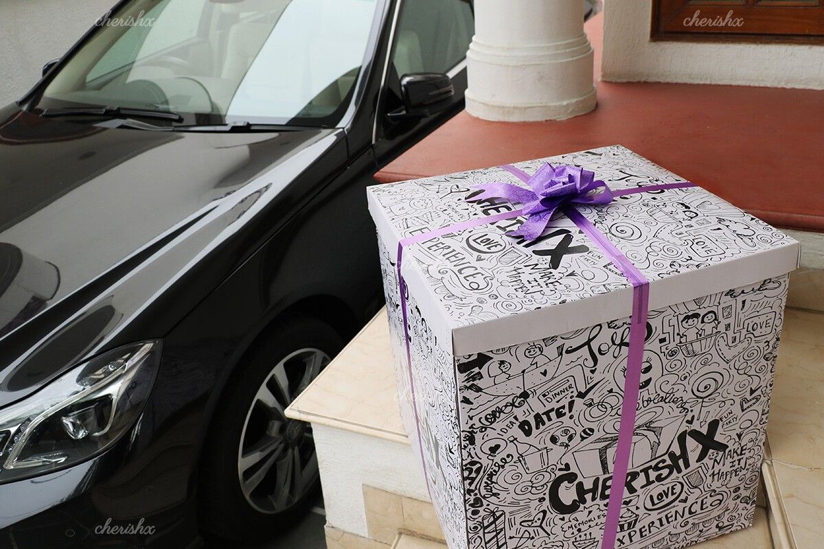 A surprise box packed with a purple ribbon.