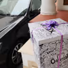 A surprise box packed with a purple ribbon.