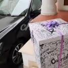 A surprise box packed with a purple ribbon.