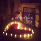 Express your love with this heart made of rose petals and candles.