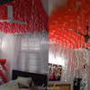 The ceiling of the room is decorated with red balloons to make the decor more beautiful.