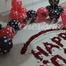 A decorated room with balloons, photos and candles for a midnight Birthday surprise.