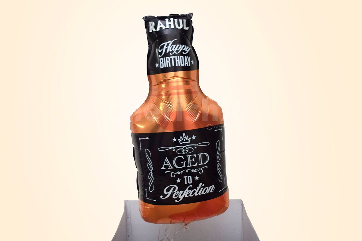 A Whiskey bottle-shaped foil balloon attached to bunches of balloon.