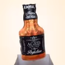 A Whiskey bottle-shaped foil balloon attached to bunches of balloon.