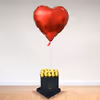A box of happiness
in the form of chocolates and a heart-shaped balloon.