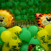 Tiger and Lion Foil Balloons surrounded by green and yellow balloons to give the look of a Jungle.