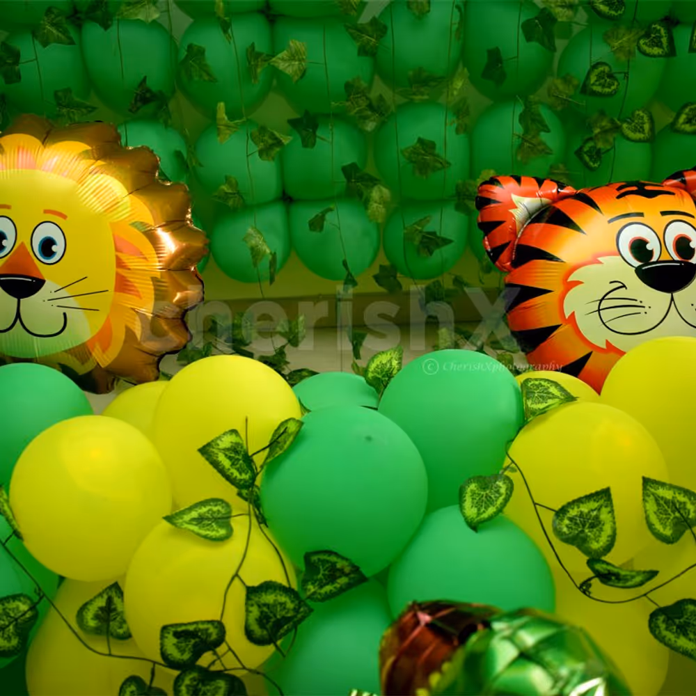 Tiger and Lion Foil Balloons surrounded by green and yellow balloons to give the look of a Jungle.