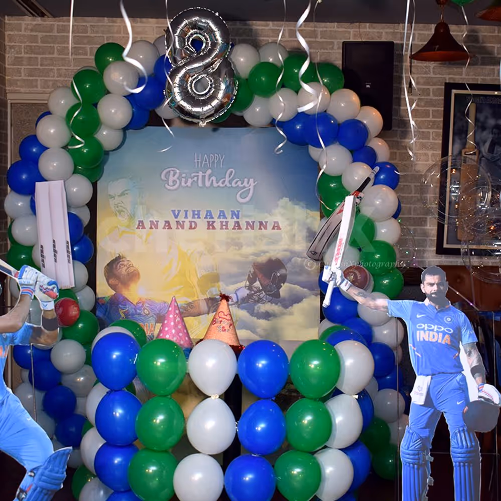 Balloon arc, a backdrop and cricket personality cut-outs for a photo booth.