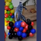 A Black Panther Cut-out stand on a colourful balloon bunch.