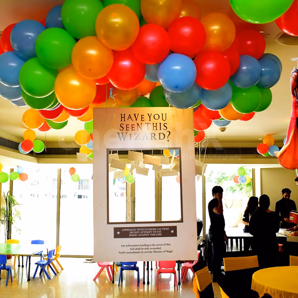 Coloured Bunches of balloons and Harry Potter Themed Photo Frame to create the Harry Potter Feels.