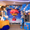 The room decoration includes a wall decorated with an arch of balloons and a parachute made out of balloons to give the look of Disney's "Up" Movie.