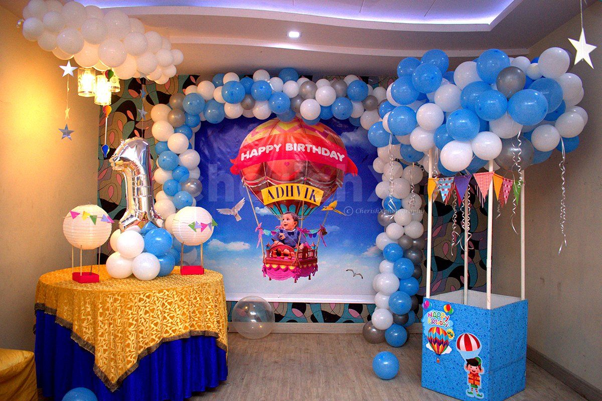 The room decoration includes a wall decorated with an arch of balloons and a parachute made out of balloons to give the look of Disney's "Up" Movie.