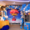 The room decoration includes a wall decorated with an arch of balloons and a parachute made out of balloons to give the look of Disney's "Up" Movie.
