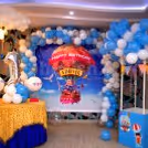 The room decoration includes a wall decorated with an arch of balloons and a parachute made out of balloons to give the look of Disney's "Up" Movie.