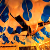 Blue and white balloons attached to the ceiling in preparation for a Balloon Surprise.