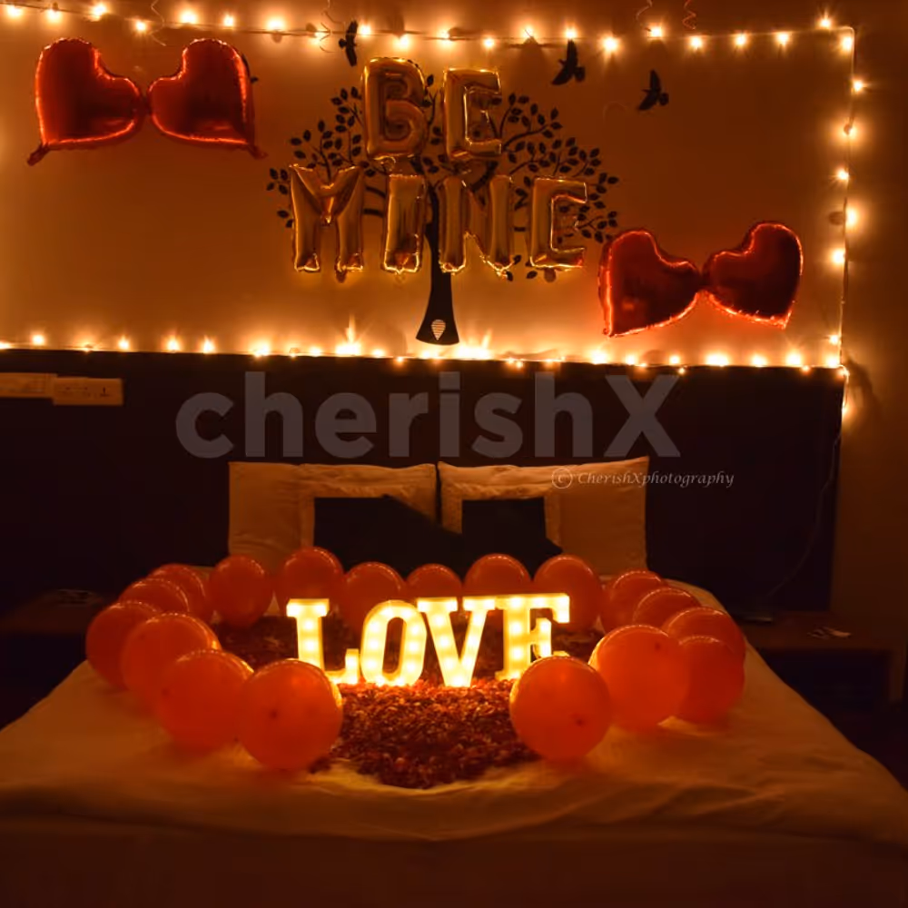 The room decor is specially curated with red balloons and lightings for a romantic feel.