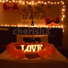 The room decor is specially curated with red balloons and lightings for a romantic feel.