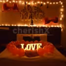The room decor is specially curated with red balloons and lightings for a romantic feel.
