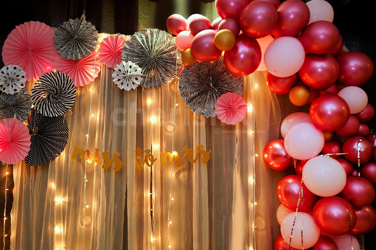 Bridal Shower Balloon Decoration with Balloons in Pink Shade and Rosettes.