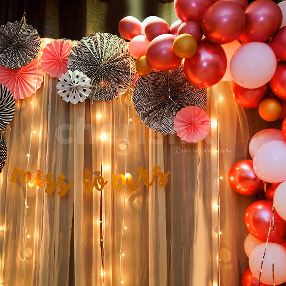 Bridal Shower Balloon Decoration with Balloons in Pink Shade and Rosettes.