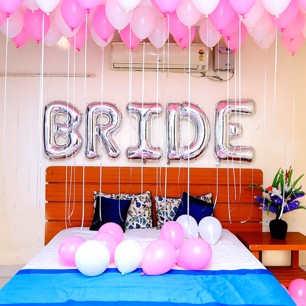 Shades of Pink Coloured Balloons are used for the ceiling and one 'BRIDE' Foil Balloon for the wall.