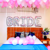 Shades of Pink Coloured Balloons are used for the ceiling and one 'BRIDE' Foil Balloon for the wall.
