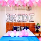 Shades of Pink Coloured Balloons are used for the ceiling and one 'BRIDE' Foil Balloon for the wall.