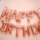 Wall decoration with Pink "Happy Birthday" Foil Balloons.