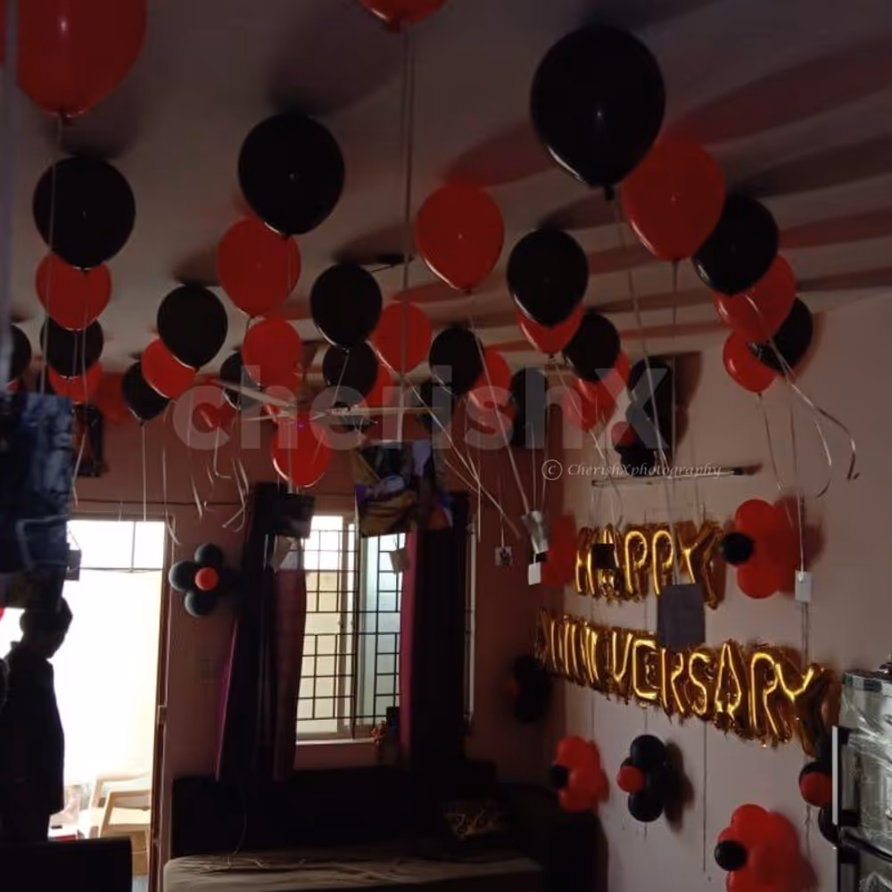 Red and Black Balloon Theme used for Anniversary Special Balloon Room Decoration.