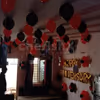 Red and Black Balloon Theme used for Anniversary Special Balloon Room Decoration.
