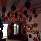 Red and Black Balloon Theme used for Anniversary Special Balloon Room Decoration.