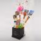 A charming bucket arranged in a beautiful way with different little gifts.