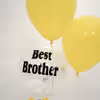 Two yellow balloons with a confetti balloon on which a message in vinyl is printed.