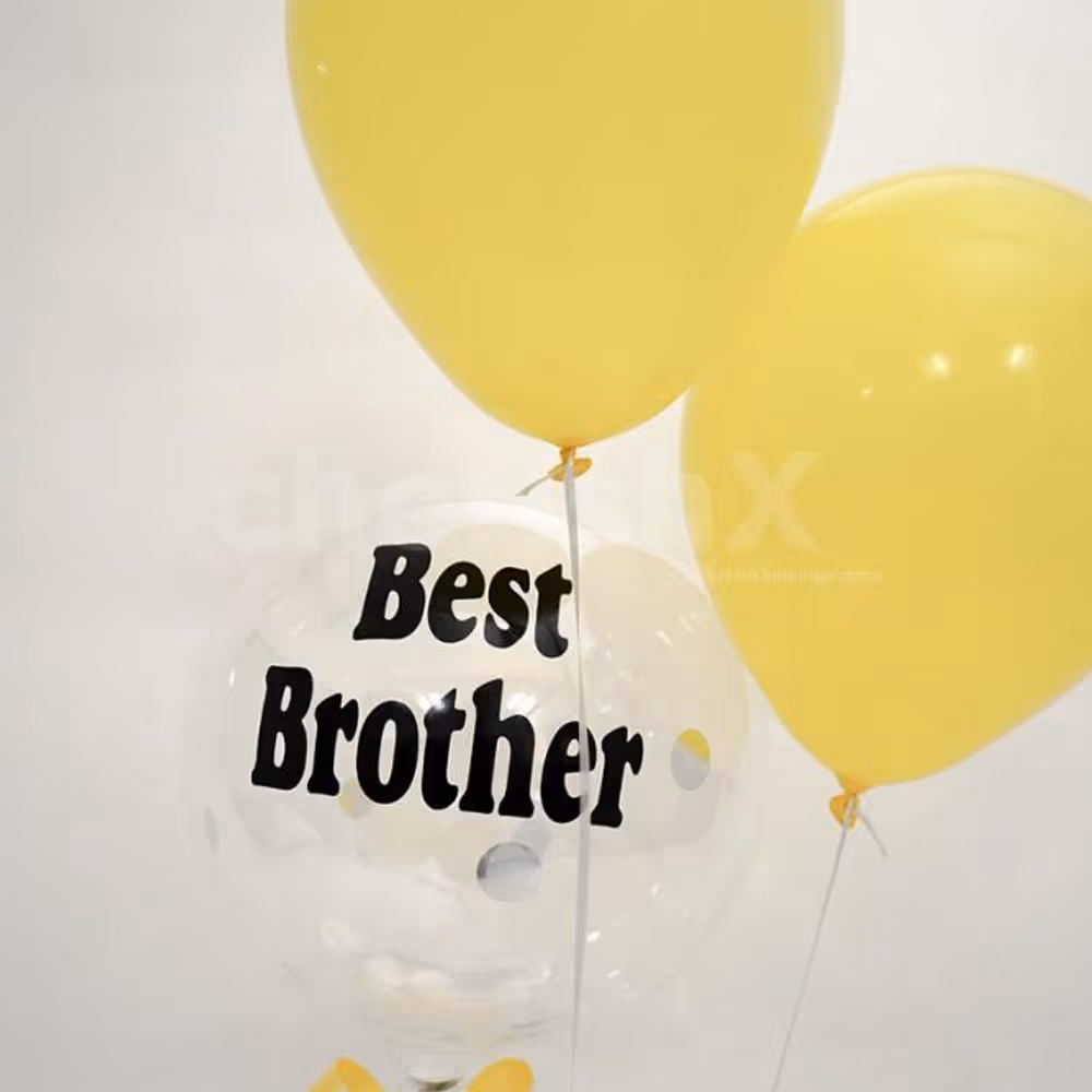 Two yellow balloons with a confetti balloon on which a message in vinyl is printed.