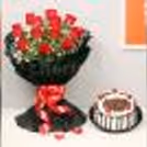 Roses in a black paper packaging with a blackforest cake