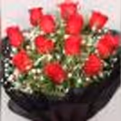 Roses in a black paper packaging with a black forest cake delivered at home by cherishx