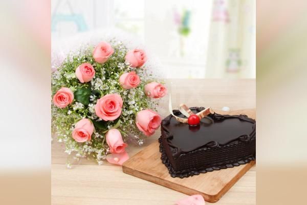 Pink roses with a heart shape chocolate truffle cake