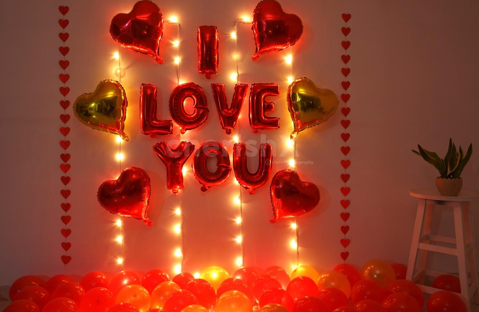 Romantic Balloon Decoration with I LOVE YOU foil balloons, heart shaped foil balloons and fairy lights