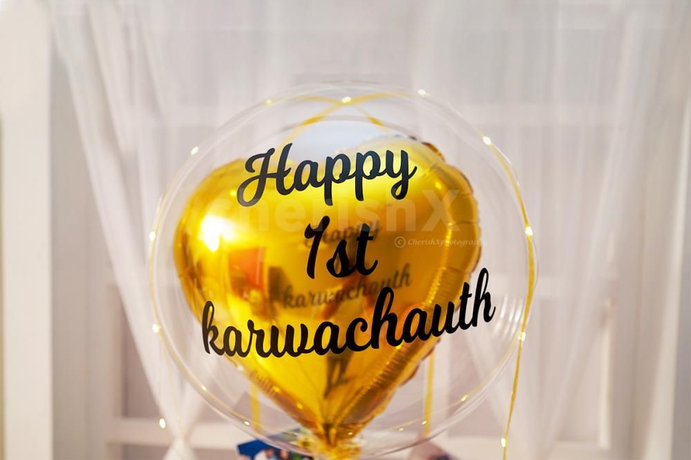 A Bubble Balloon with a Golden Heart-shaped foil balloon.