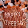 The decor includes "Happy Anniversary" Foil Balloons and bunches of different colored balloons.
