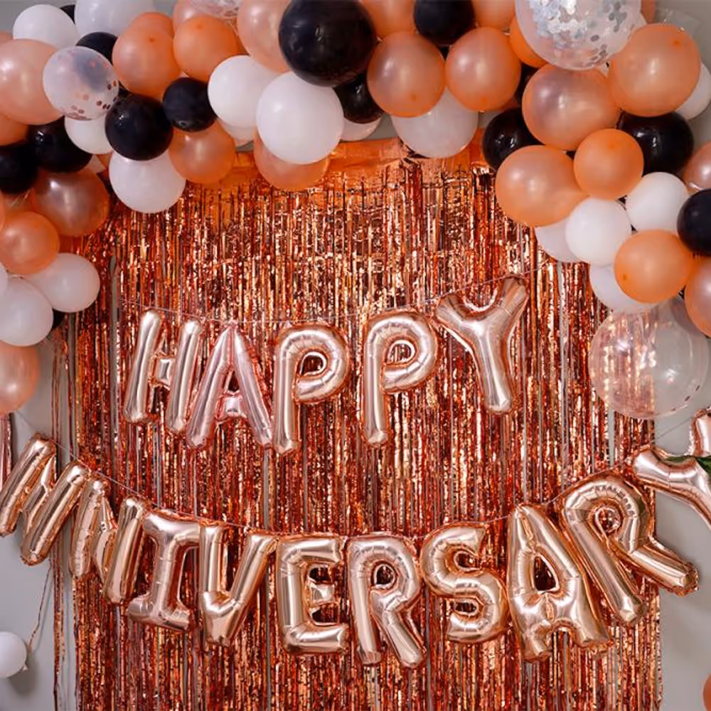 The decor includes "Happy Anniversary" Foil Balloons and bunches of different colored balloons.