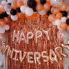 The decor includes "Happy Anniversary" Foil Balloons and bunches of different colored balloons.