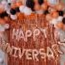 The decor includes "Happy Anniversary" Foil Balloons and bunches of different colored balloons.