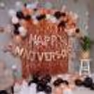 The Decor is filled with Rosegold, White and Black Balloons.