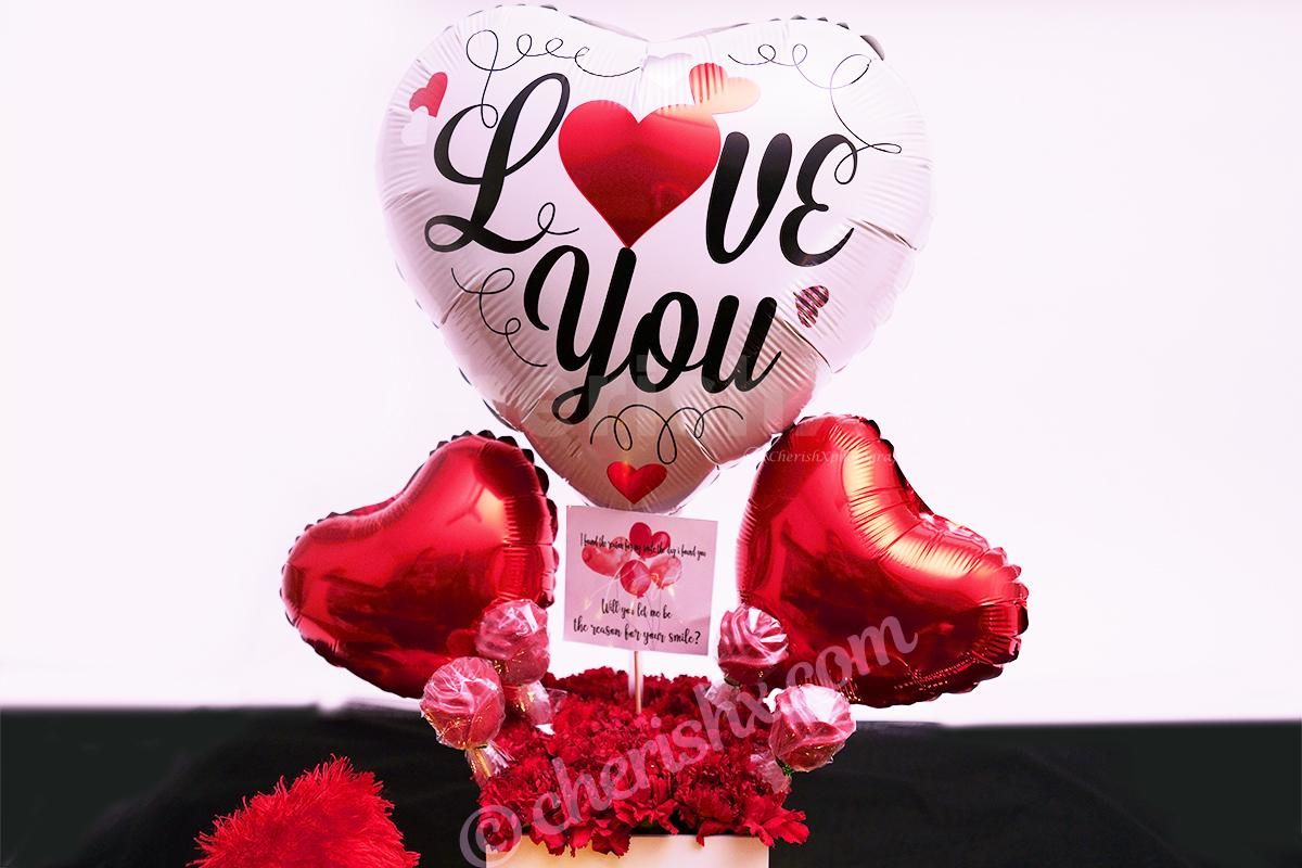 Surprise your loved one with CherishX's White & Red Colored Rose Day Bucket!